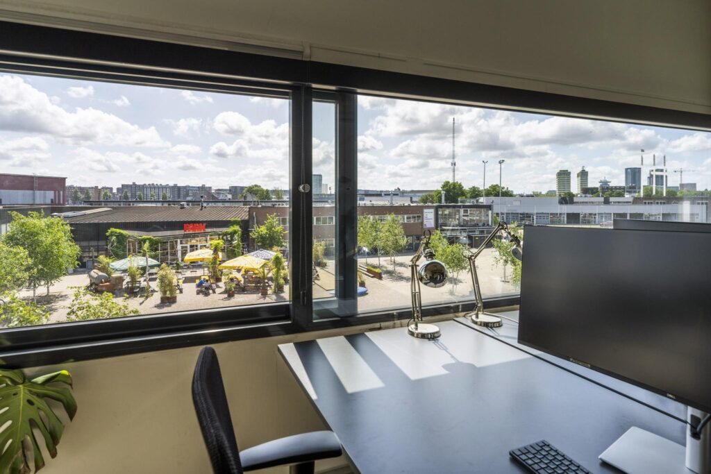 Modern office desk with a city view overlooking PARK at Johan van Hasseltweg in Amsterdam.
